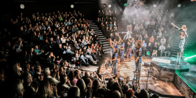 016_Bolton Octagon Theatre_Pamela Raith Photography Birdseye shot og animal farm performance taking place in theatre with audience on looking the stage.